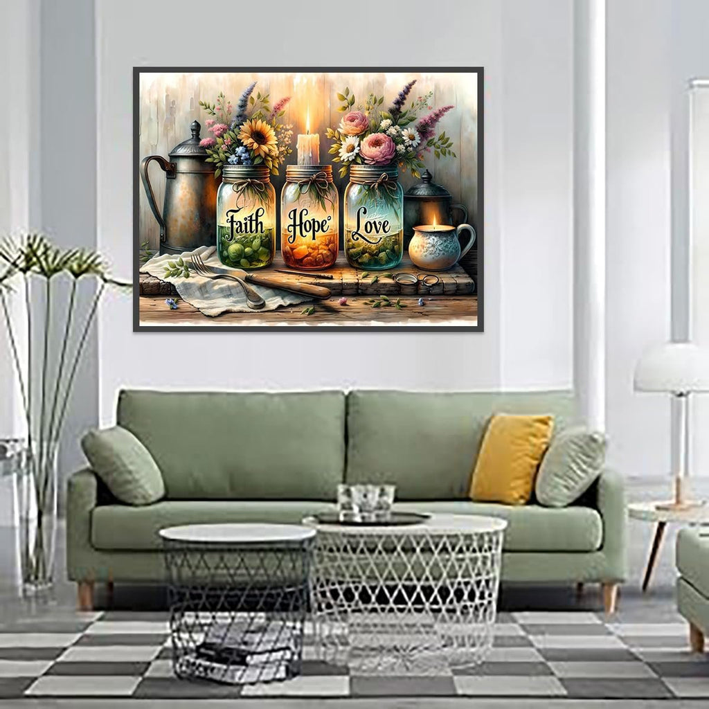 Three glass jars with flowers and a candle, labeled Faith, Hope, Love, on a wooden shelf with a pitcher and mug.