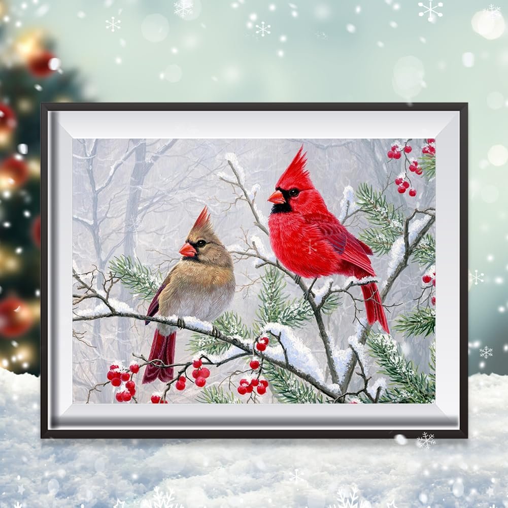 Diamond art painting kit showing two cardinals perched on a snow-covered branch with red berries, winter forest background.