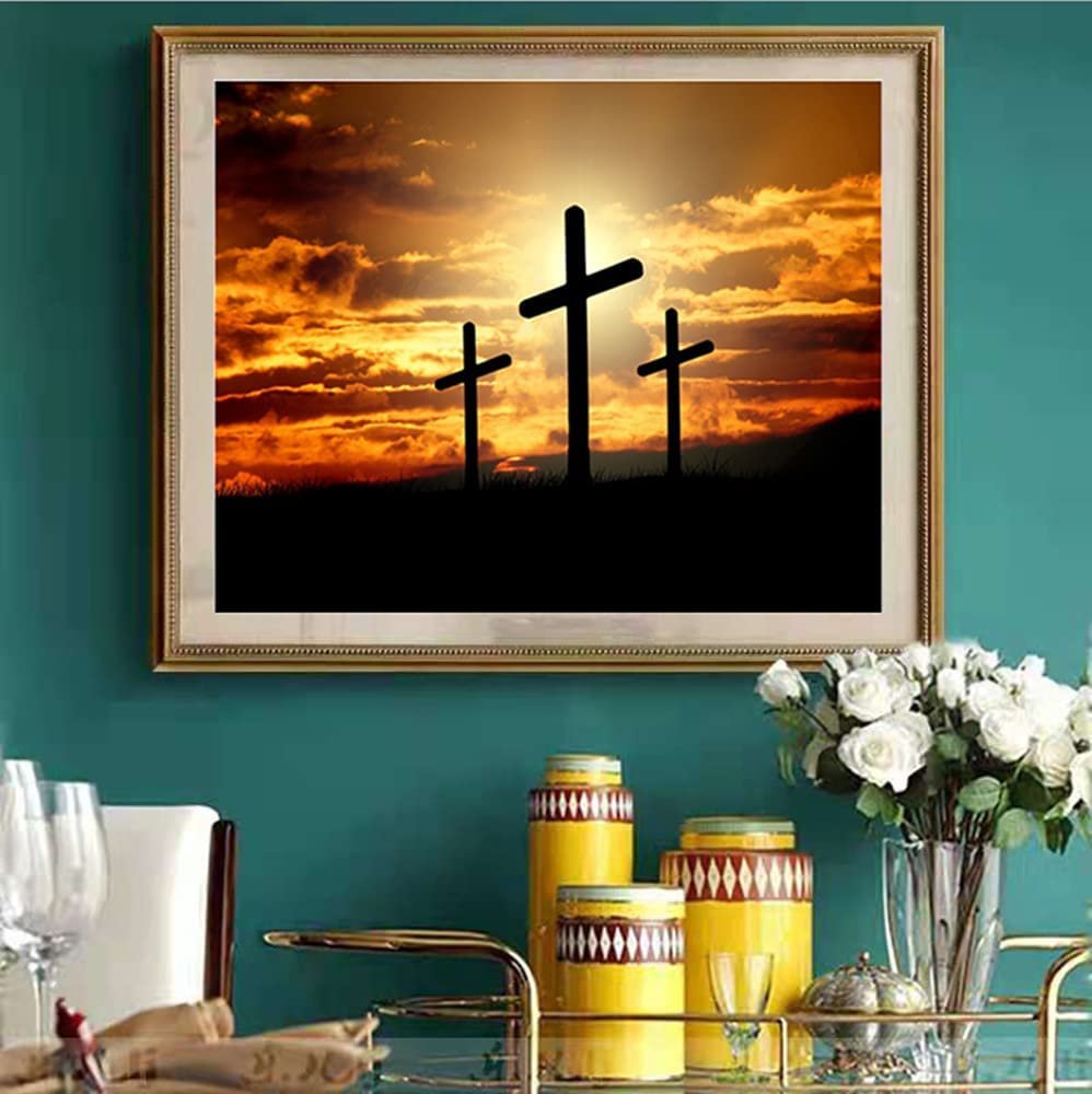 Framed diamond painting of three crosses silhouetted against a dramatic sunset sky.