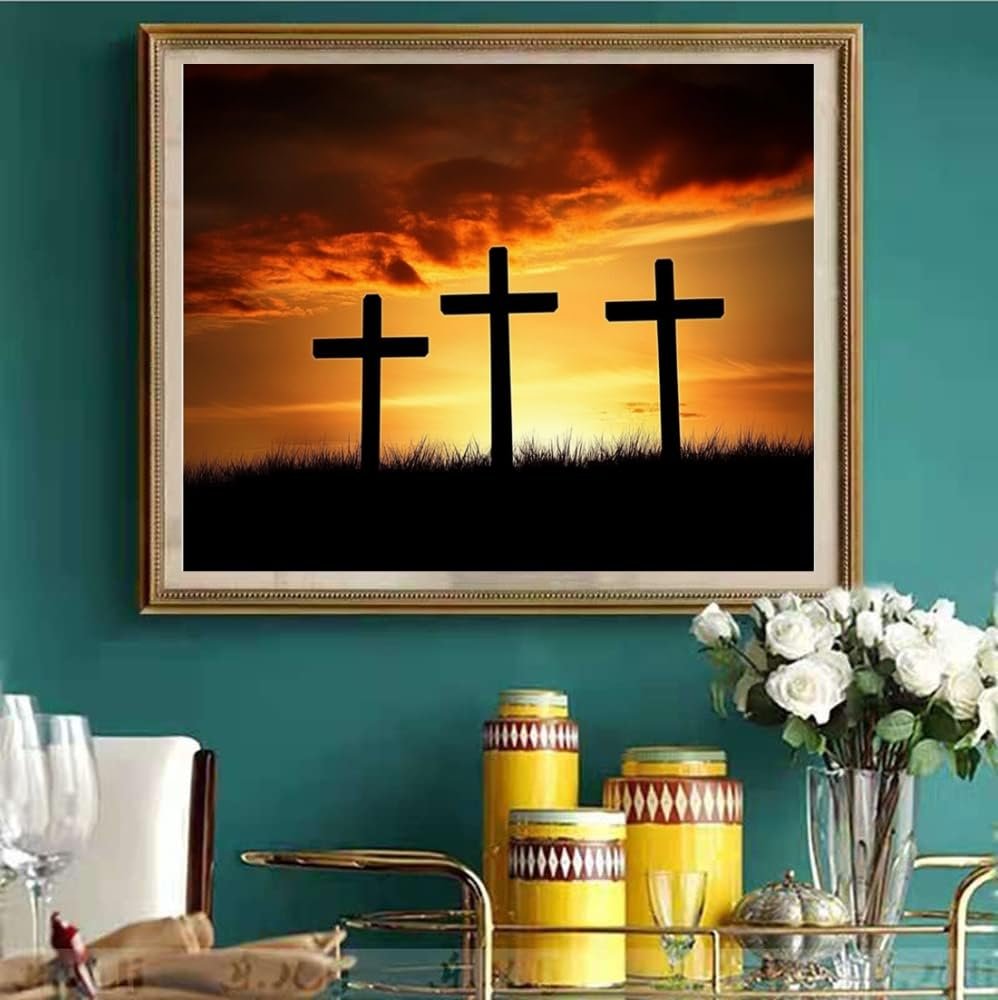 Framed diamond painting of three crosses silhouetted against a dramatic sunset sky.