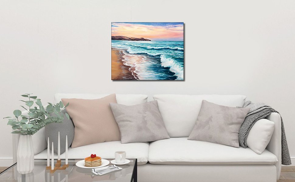 16x20 inch beach landscape painting of ocean waves on a sandy shore displayed above a white sofa