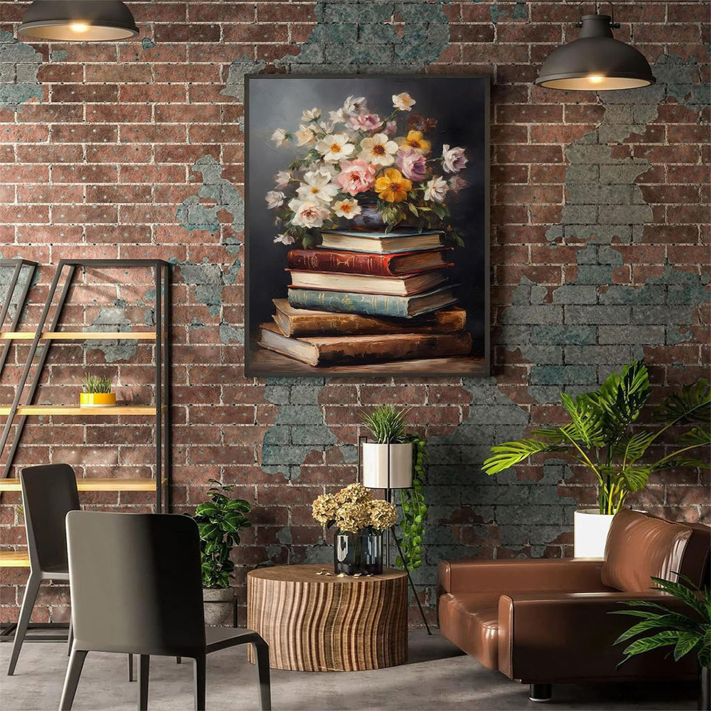 Framed painting of a stack of antique books with a floral arrangement on top, displayed in a living room setting.