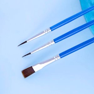 Three paint brushes with blue handles and silver ferrules on a light blue background.