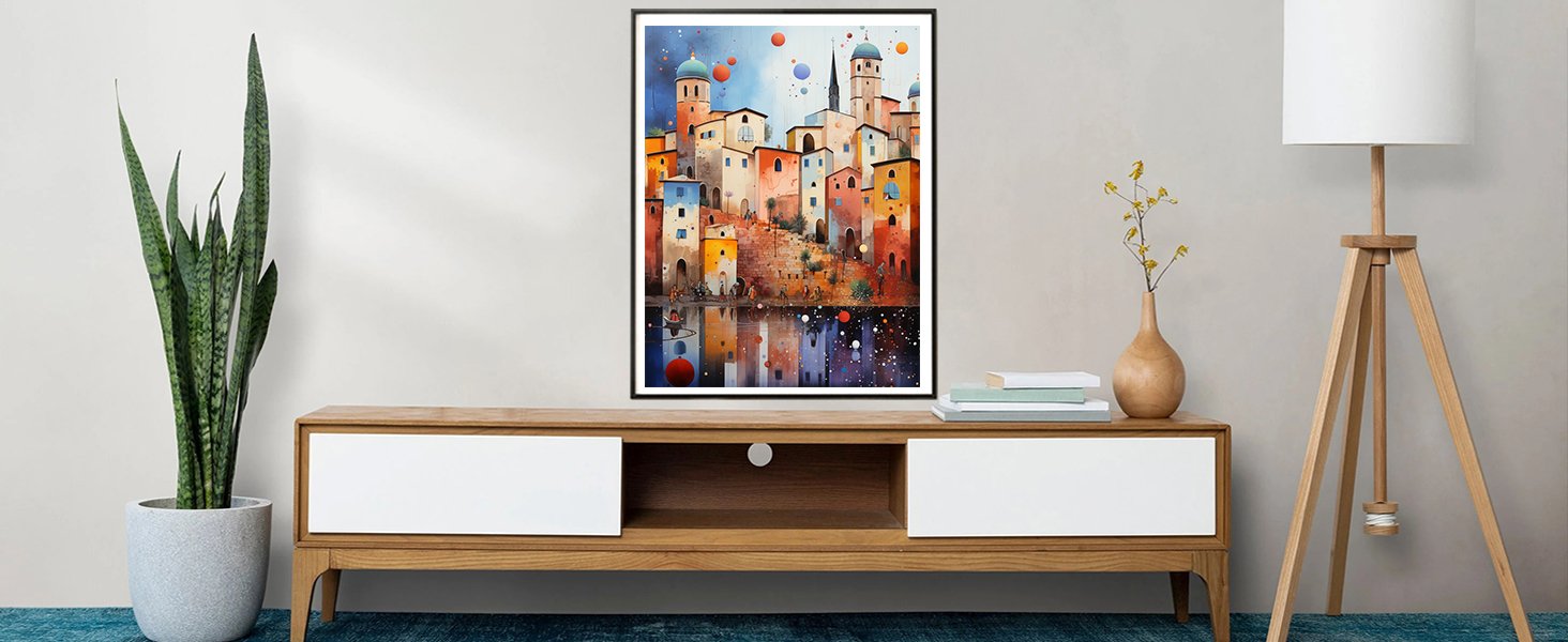 Framed watercolor painting of a colorful Mediterranean village reflected in water, displayed above a wooden media console.