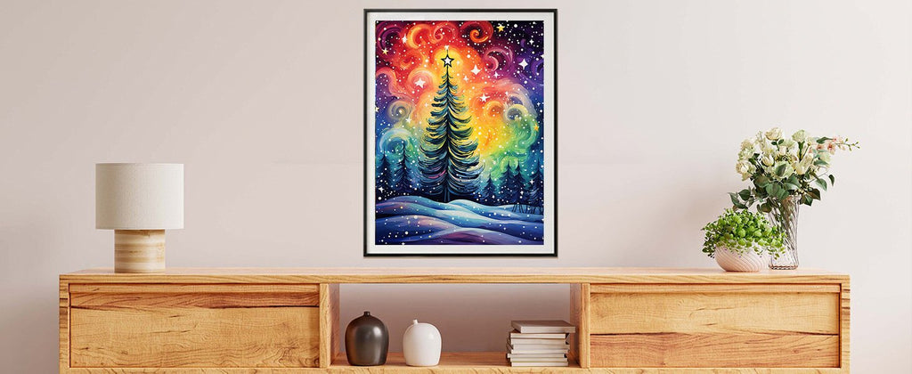 Framed Christmas tree painting with colorful starry sky and snowy landscape, displayed on a wooden console table.