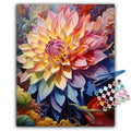 Paint by numbers kit showing a vibrant, colorful dahlia flower with abstract swirling background, with brushes and numbered paint pots.