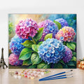Paint by numbers kit with hydrangea flowers in pink, blue, and purple watercolor tones, includes paint pots and brushes.