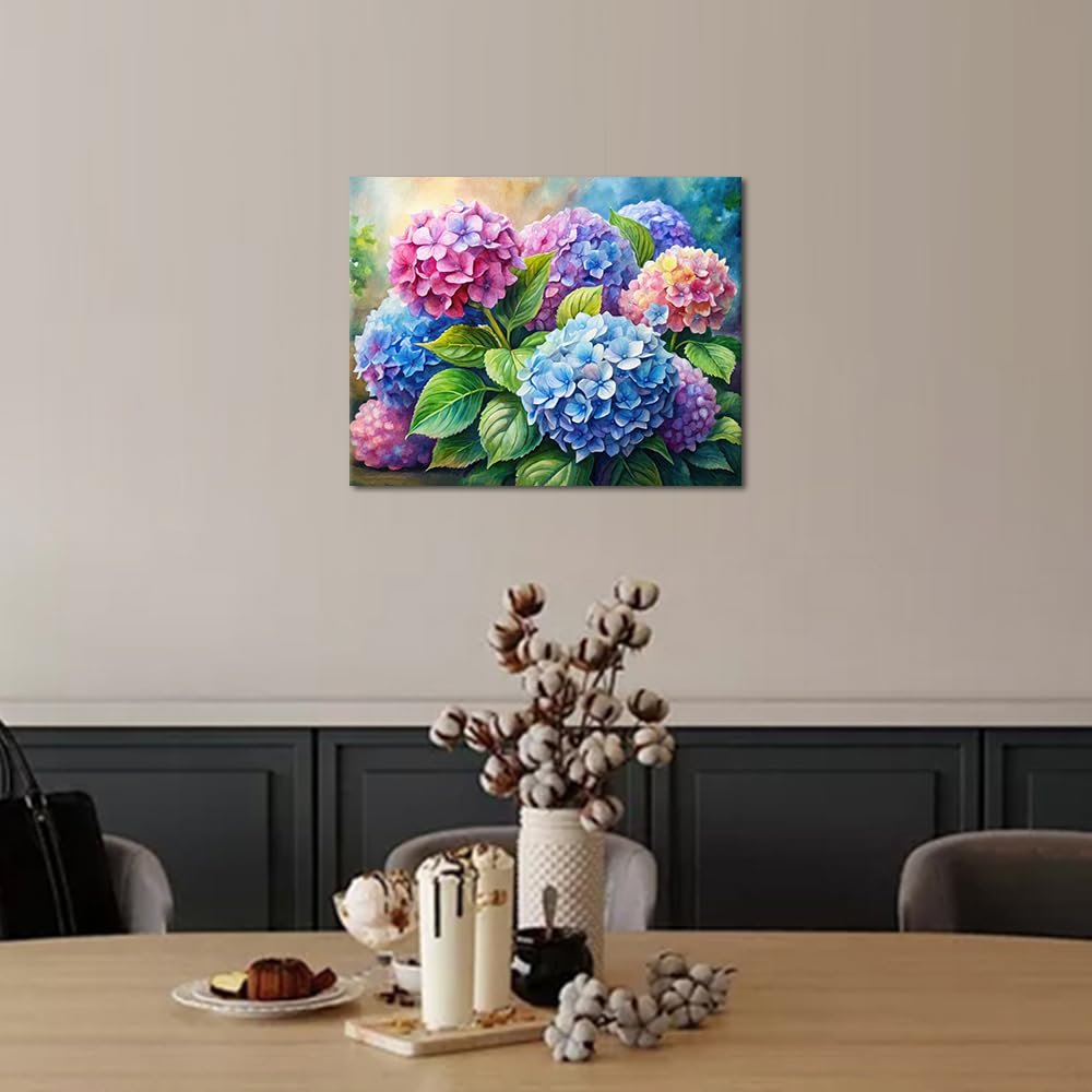 Paint by numbers canvas featuring a watercolor design of pink and blue hydrangeas hanging on a wall above a dining table.