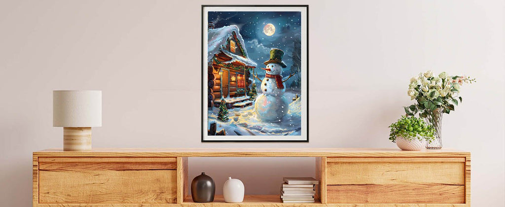 Paint by numbers canvas showing a snowman in front of a log cabin on a snowy night.