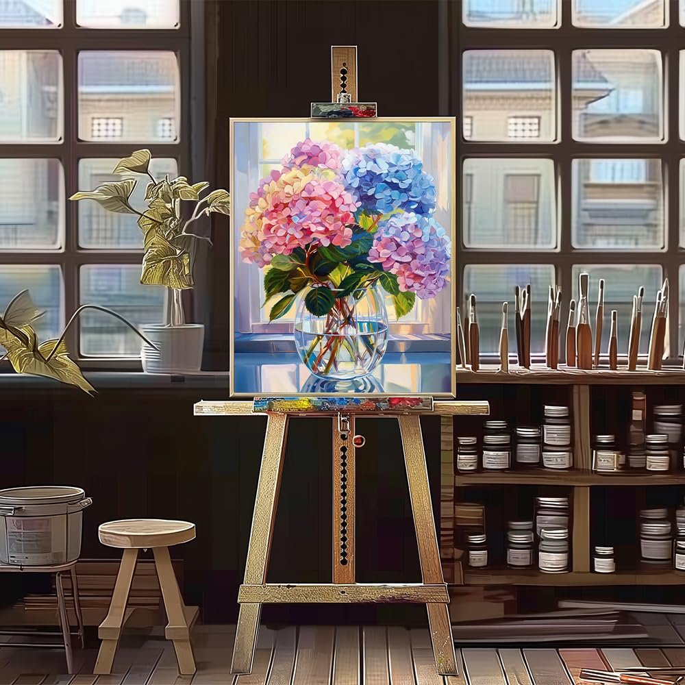 Paint by numbers canvas of colorful hydrangeas in a glass vase on an easel in an art studio setting.