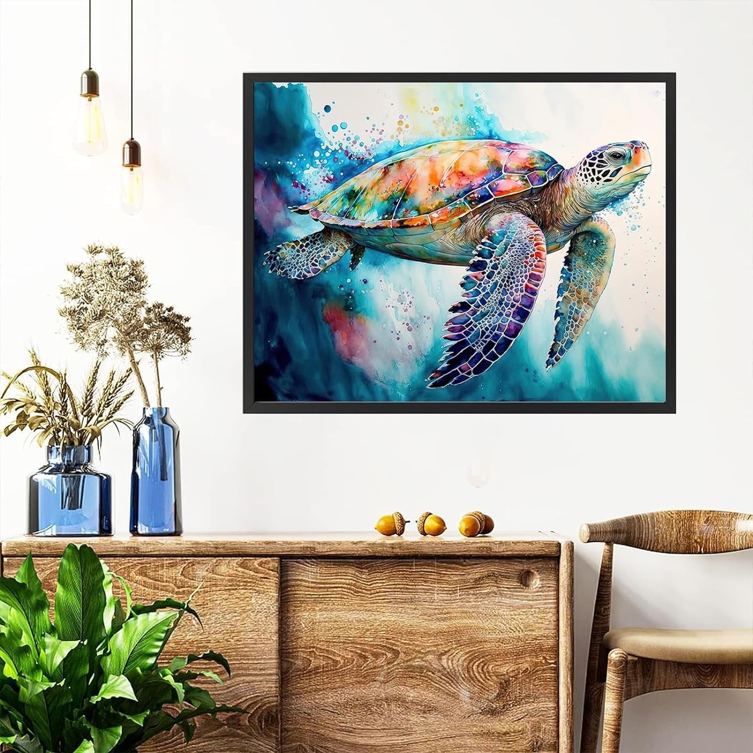 Colorful sea turtle painting hanging on a wall above a wooden cabinet with plants and acorns.