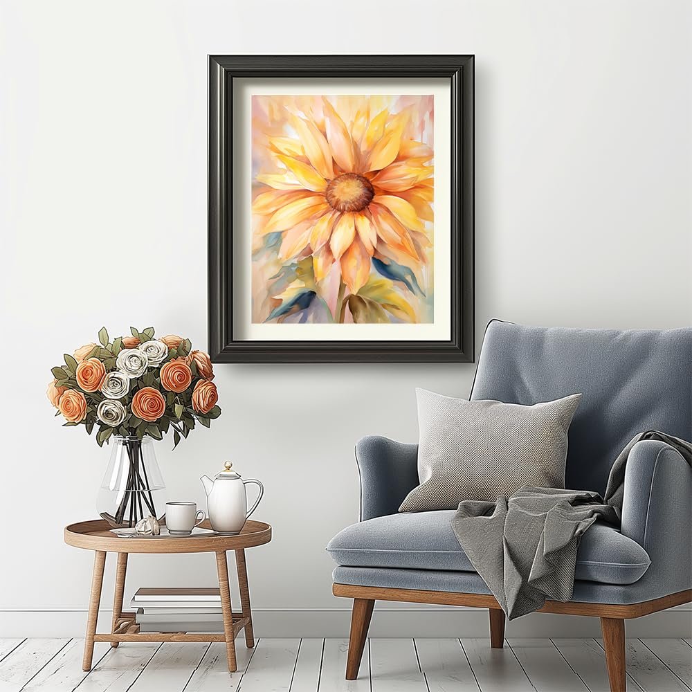Framed sunflower painting hanging on a wall above a chair with a side table.