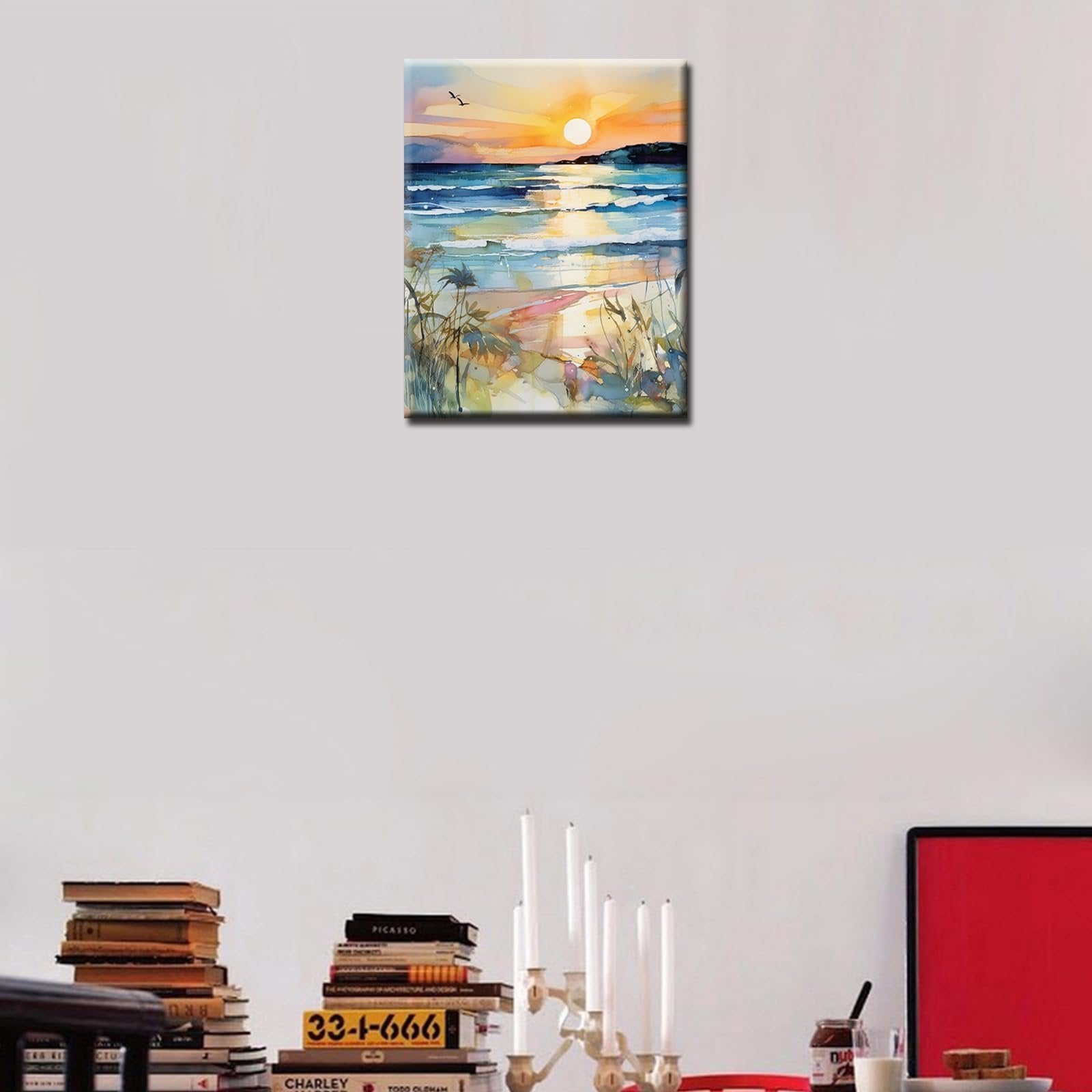 Watercolor painting of a sunset beach scene with waves, sand, and birds in the sky, displayed on a wall.