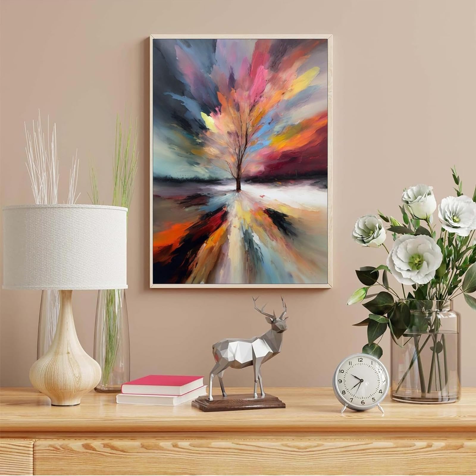Abstract tree of life painting in a frame, displayed on a wall above a wooden table with decor.