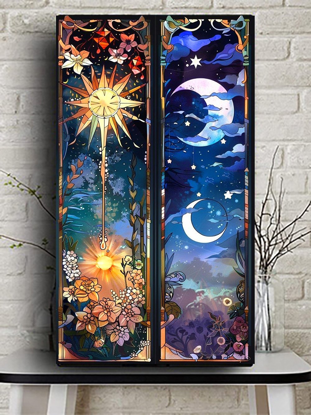 Two vertical stained glass style panels depicting sun and moon motifs with floral accents, displayed on a shelf against a brick wall.