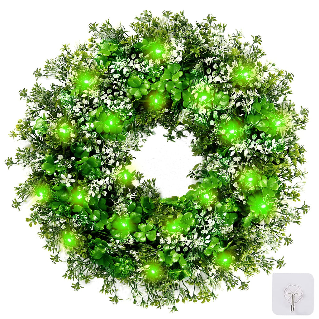 St. Patrick's Day shamrock wreath with green LED lights, plastic clover and flower accents, shown on a white background with a hook accessory.