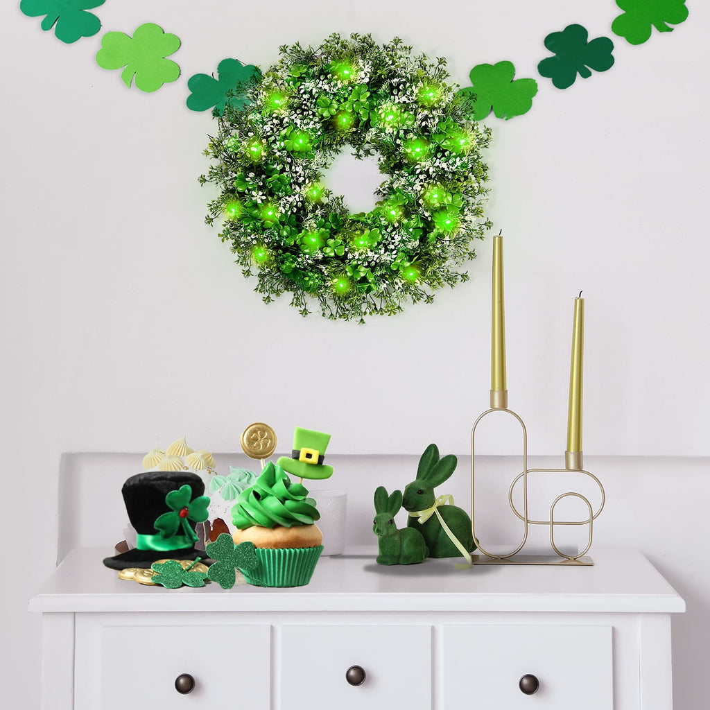 St. Patrick's Day themed display with a shamrock wreath, cupcake, and decorative bunnies on a white dresser.