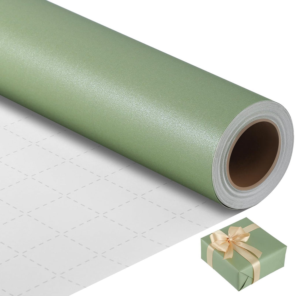 Sage green textured wrapping paper roll with grid lines on the unrolled portion, and a small gift box with a gold ribbon.
