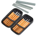 Two black zippered cases open, revealing wood carving tools with wooden handles. Four sharpening stones are arranged above the cases.