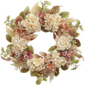Fall wreath with faux hydrangea, pampas grass, burlap ribbon, and berries on a white background.