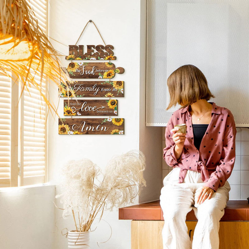 Wooden sunflower kitchen wall sign with rope, reading 'Bless the Food before us, Family Beside Us, And the Love between us, Amen'