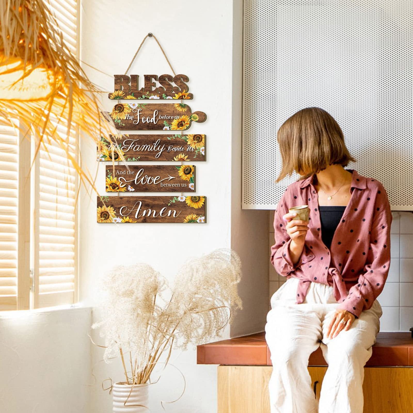 Wooden sunflower kitchen wall sign with rope, reading 'Bless the Food before us, Family Beside Us, And the Love between us, Amen'