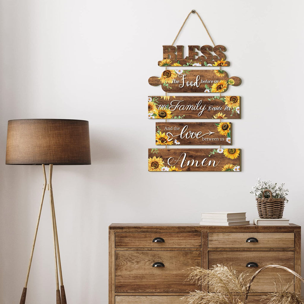 Wooden sunflower kitchen wall sign with rope, reading 'Bless the Food before us, the Family beside us, and the Love between us. Amen.'