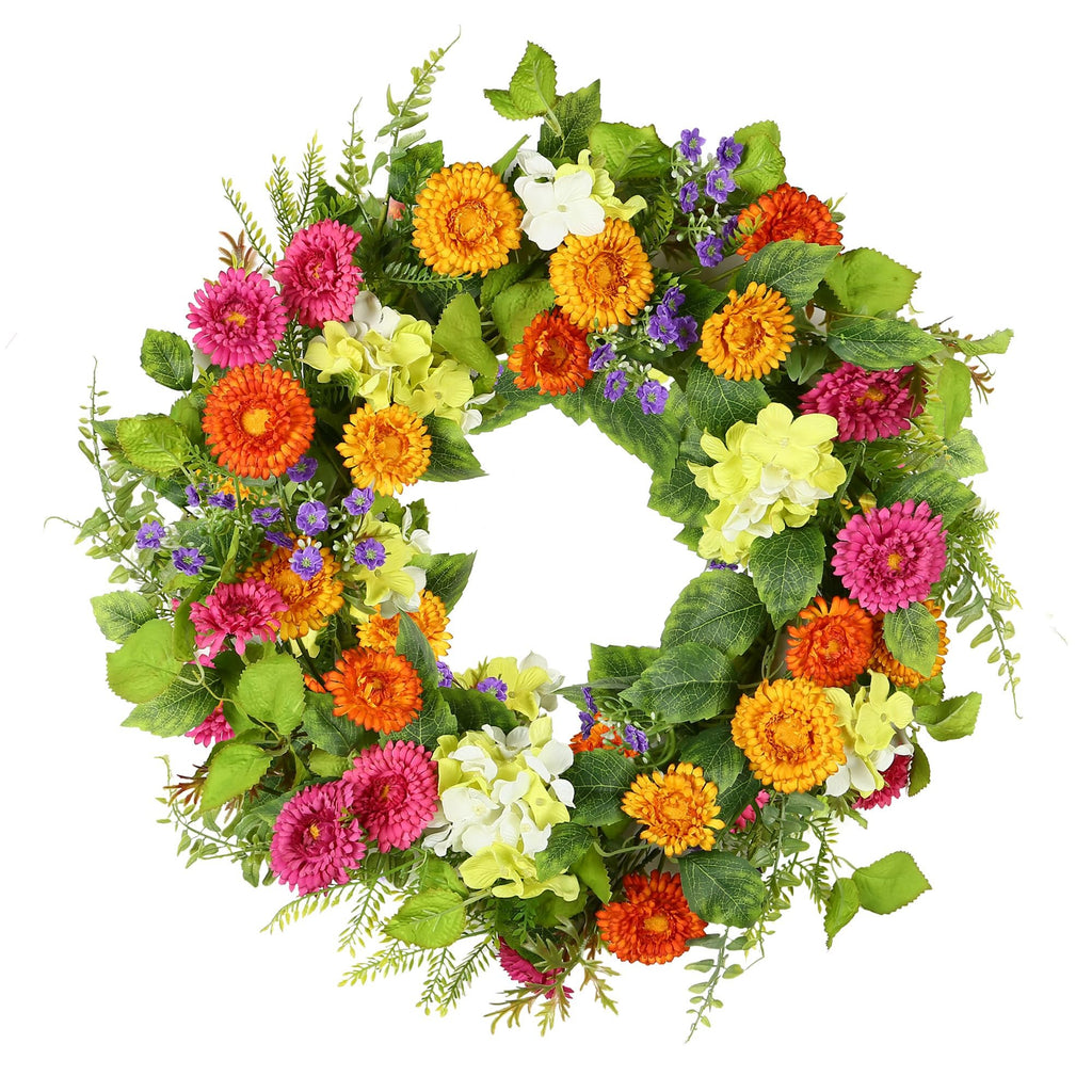 Artificial daisy wreath with green leaves, pink, orange, yellow, and white flowers on a white background.