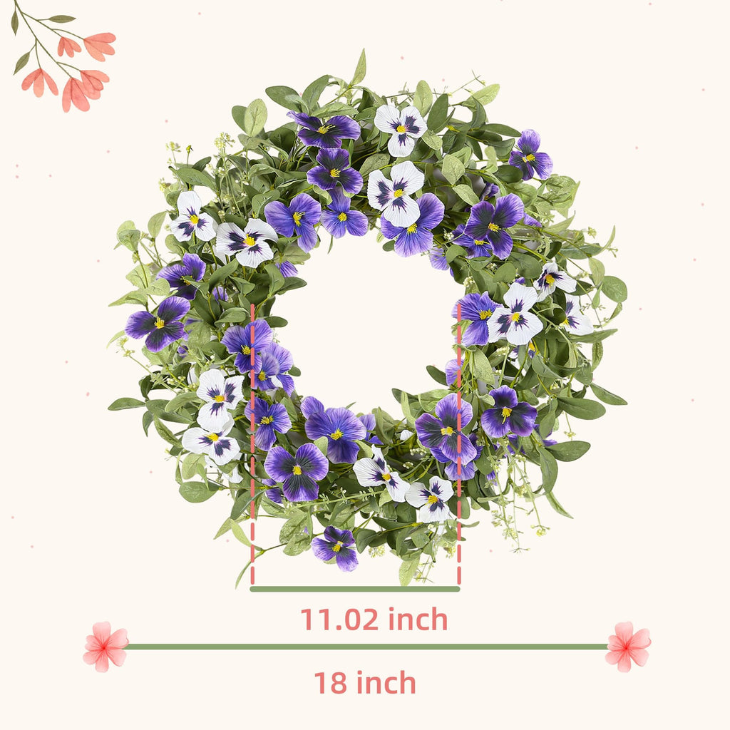 Artificial floral wreath with purple and white pansies and green eucalyptus leaves, showing 18 inch diameter.