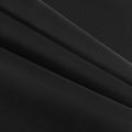 Black Aida cloth cross stitch fabric folded to show texture and weave, close-up detail.