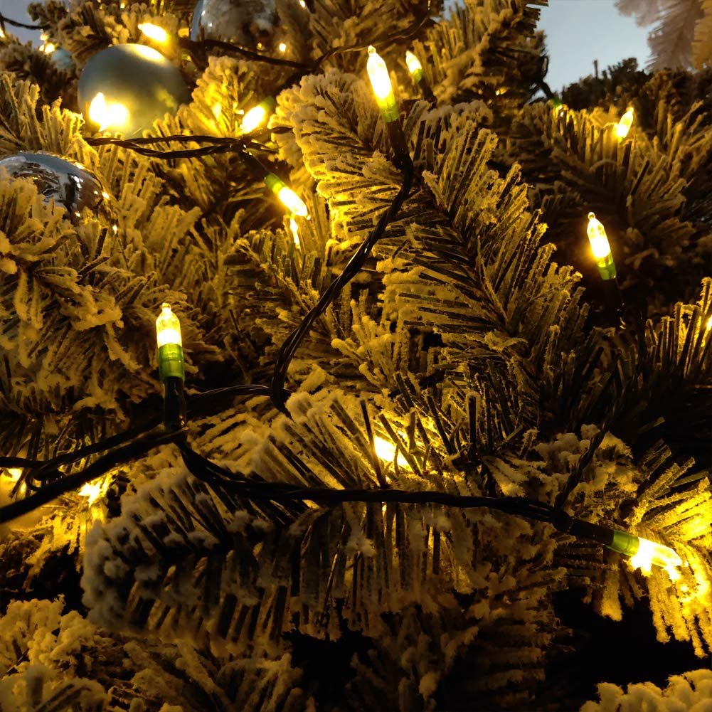 Warm white LED string lights on a frosted Christmas tree with blue ornaments.