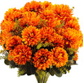 Close-up of an 18-head artificial mum fall bouquet with wheat grass, featuring vibrant orange flowers and green foliage against a white background.
