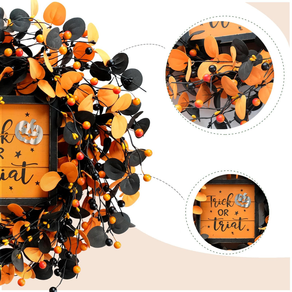 Halloween wreath with orange and black eucalyptus leaves and berries, featuring a wooden sign that says 'Trick OR Treat' with a pumpkin graphic.