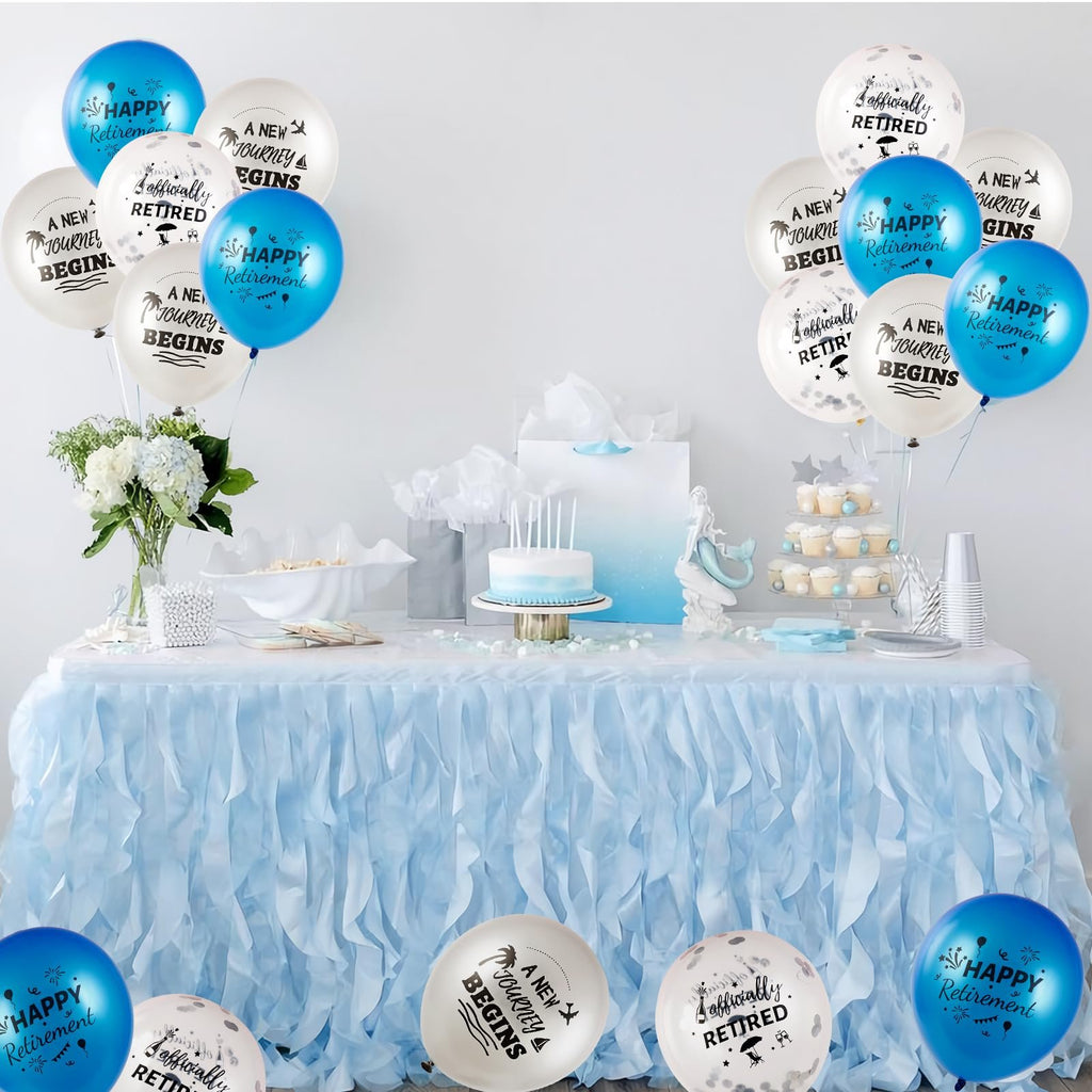 Retirement party table setting with blue and white balloons, cake, cupcakes, and flowers.