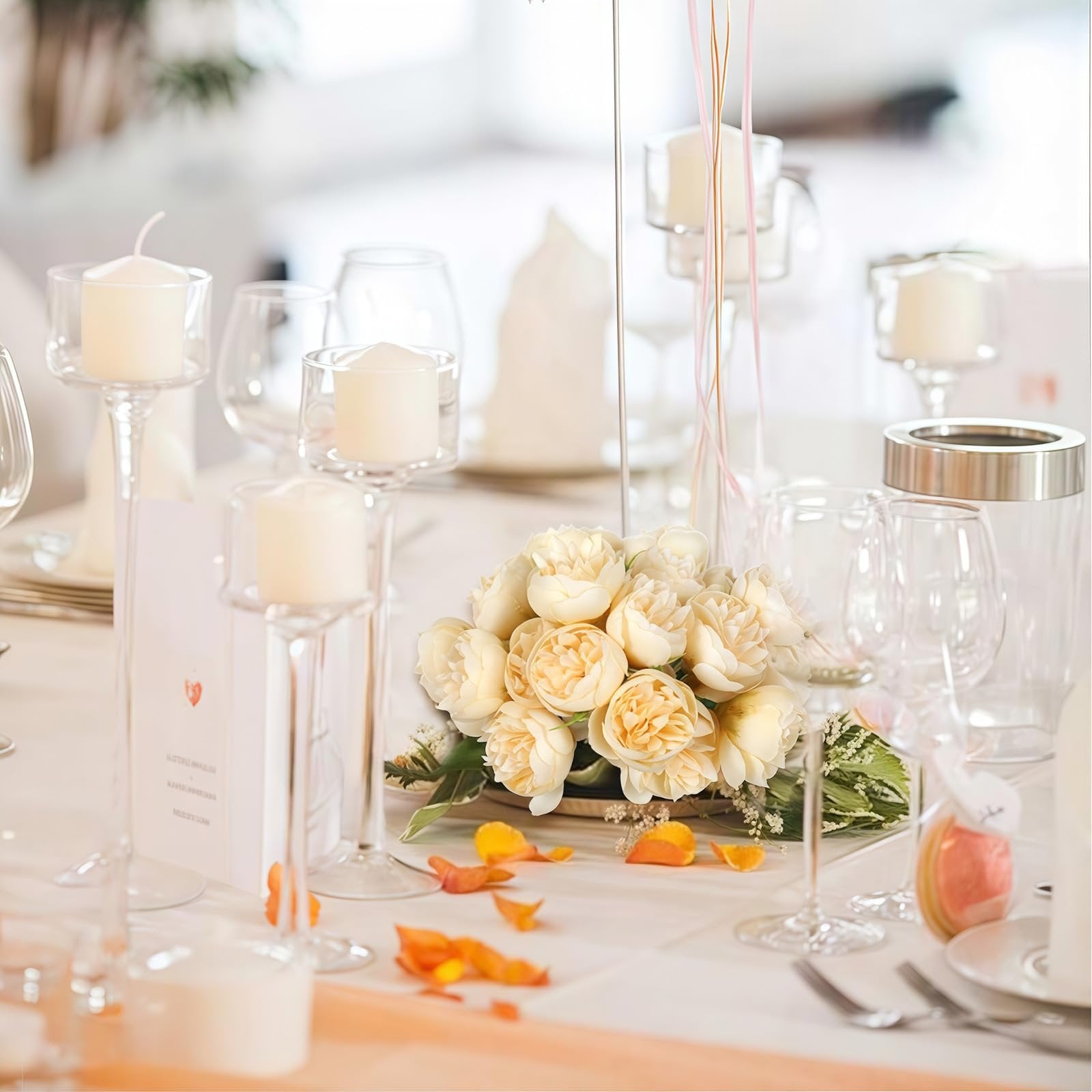 Champagne artificial peonies bouquet on a decorated wedding table with candles and glassware