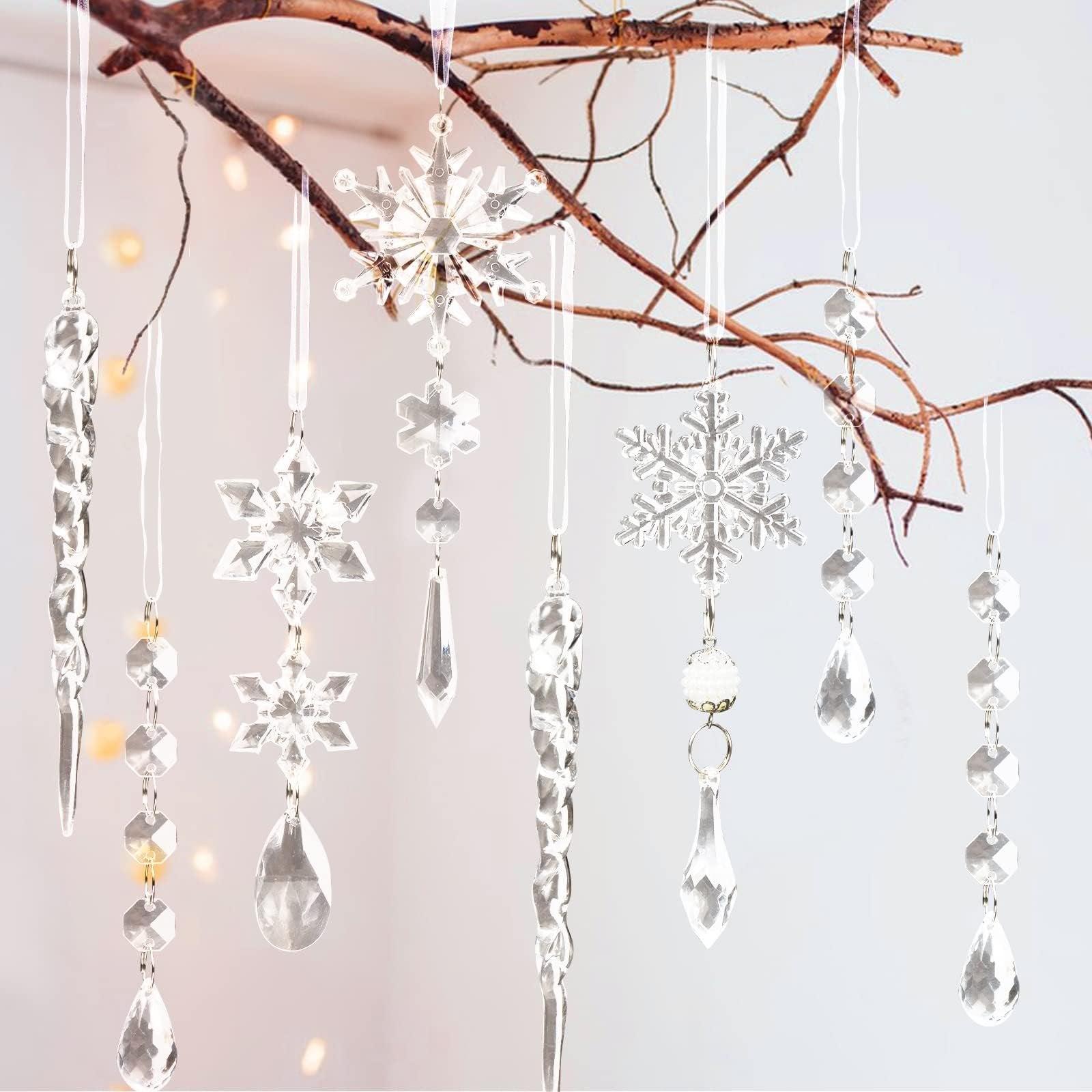 Clear acrylic Christmas ornaments including snowflakes, icicles, and bead garlands hanging from a branch.