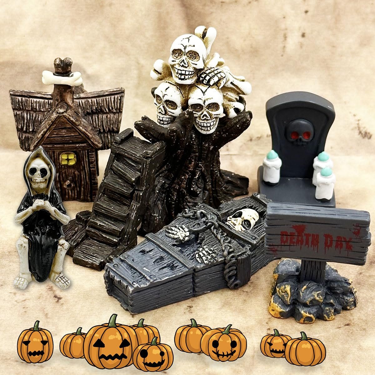Halloween miniature figurines including a grim reaper, haunted house, coffin, tombstone, and pumpkins.