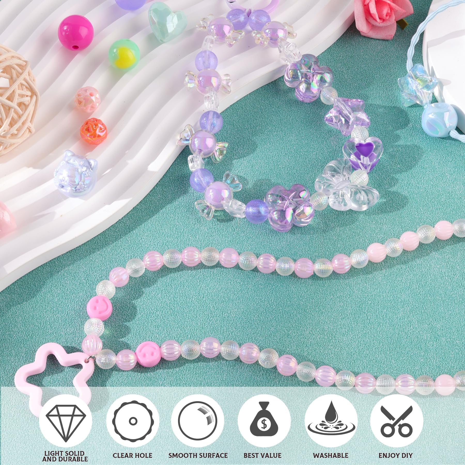 Assorted acrylic beads and charms for DIY jewelry making, including flower, heart, and candy shapes, displayed with finished bracelets.