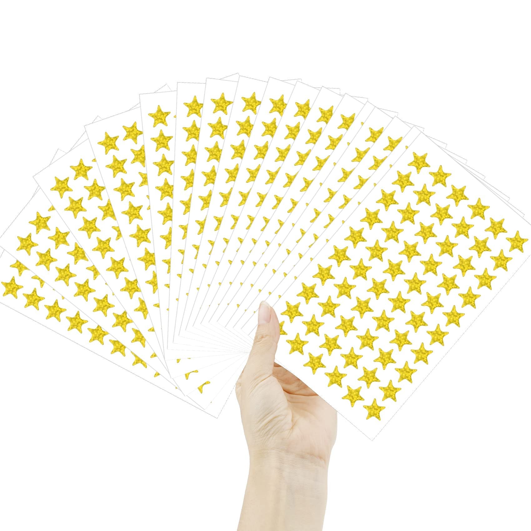 Hand holding fan of sheets with holographic gold star stickers