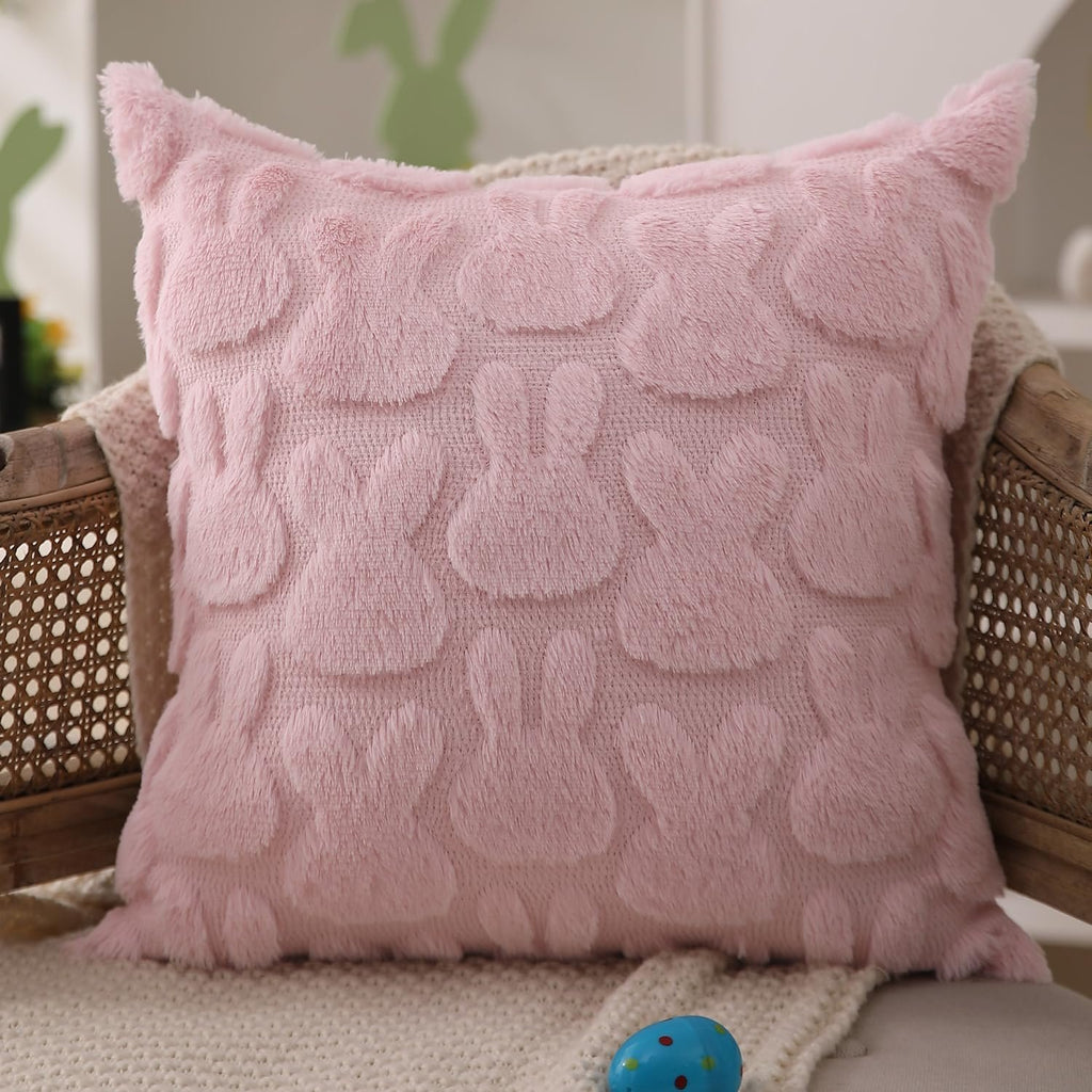 Pink plush faux fur Easter rabbit throw pillow cover on a chair with a blanket and an egg.