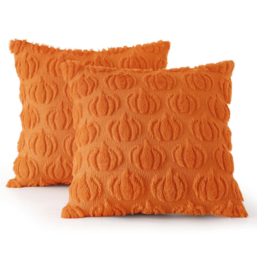 Two orange faux fur pumpkin-patterned throw pillow covers on a white background.