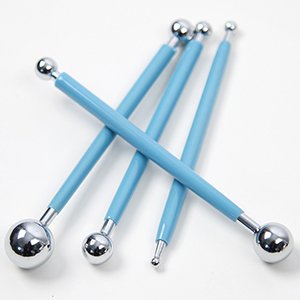 Four blue and silver mandala dotting tools with various sized ball tips on a white background