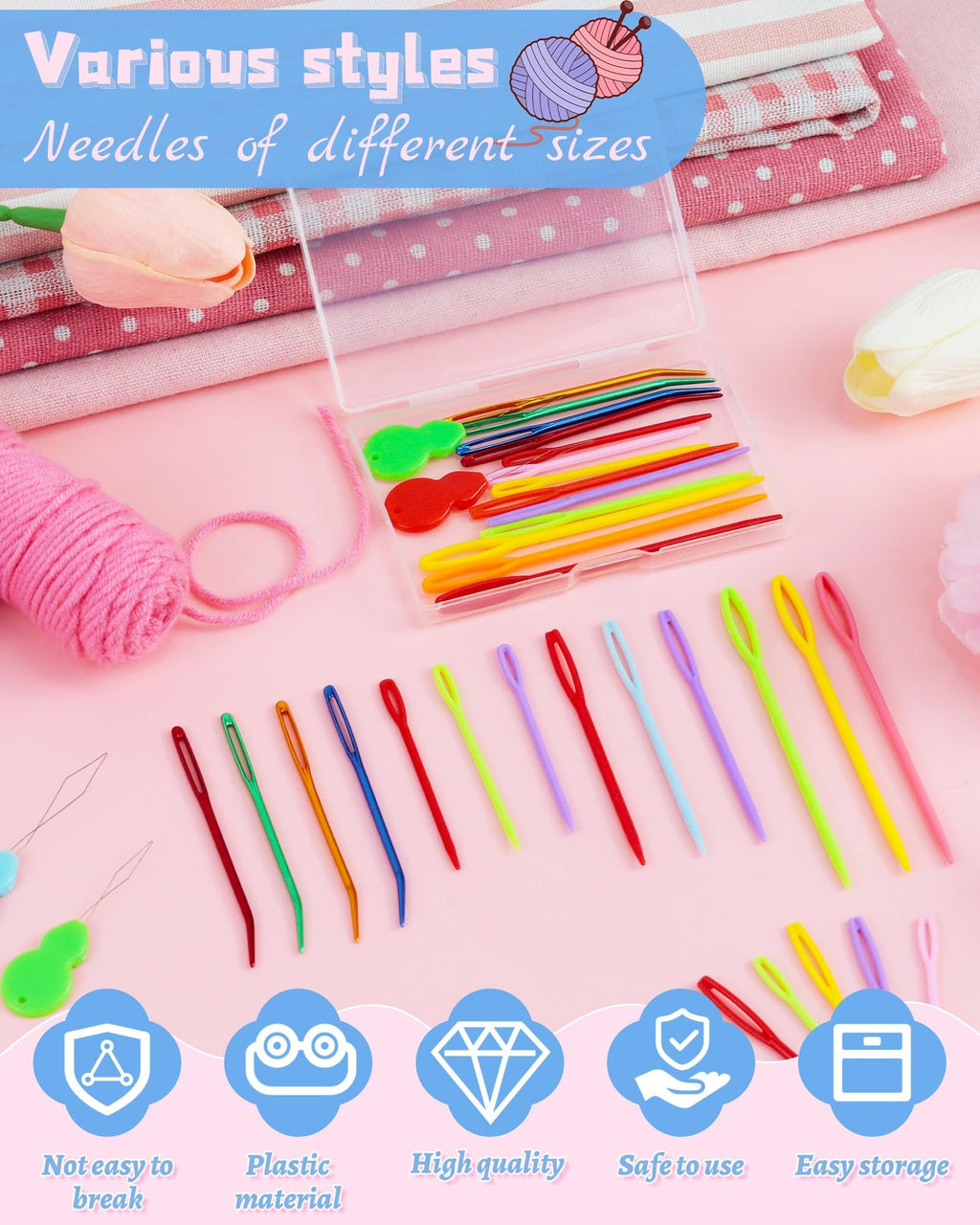 Various styles of yarn needles and threaders laid out with a pink yarn ball and fabric.