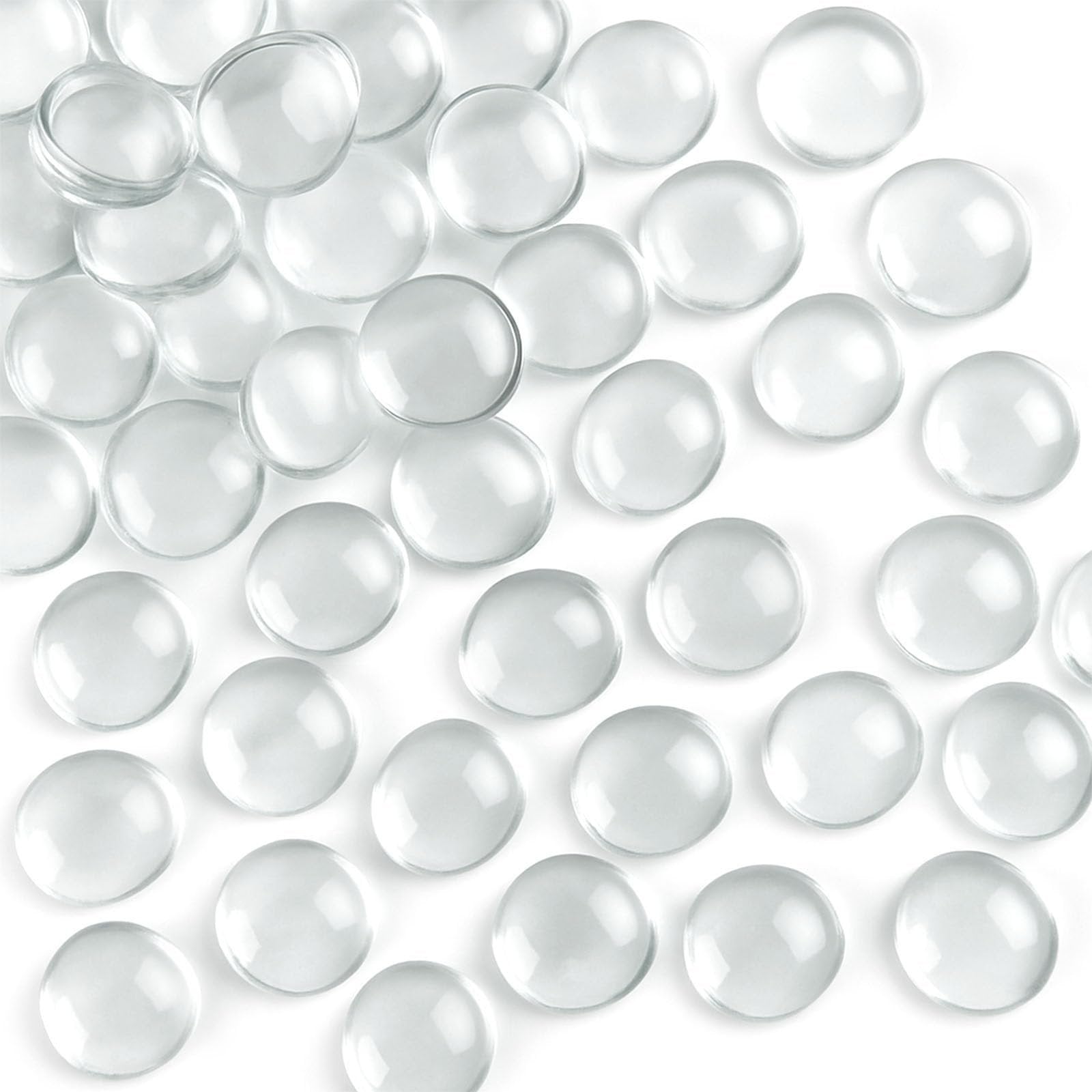 Scattered clear flat glass marbles on a white background, showing their rounded tops and flat bottoms.