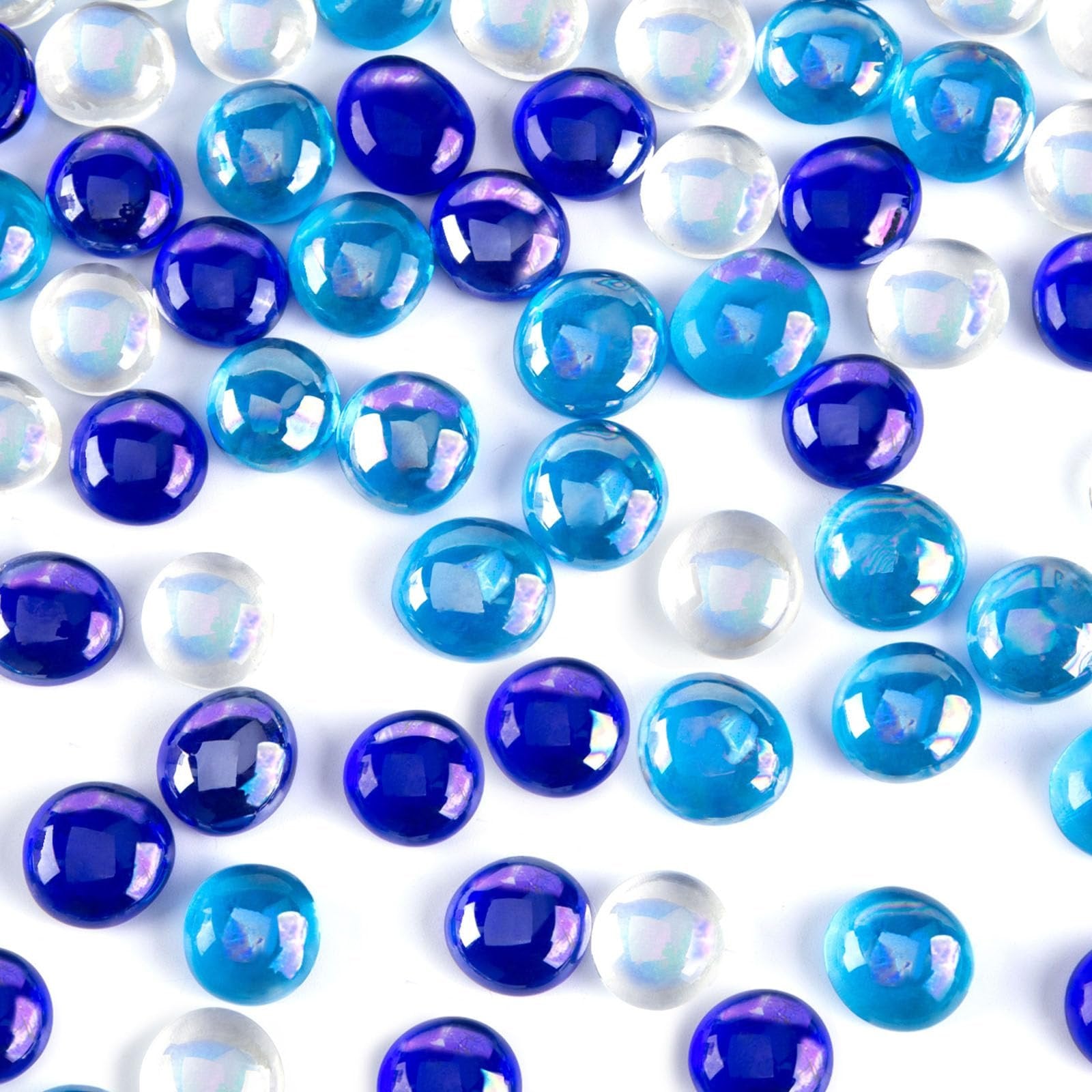Mixed blue and iridescent flat glass marbles scattered on a white background.