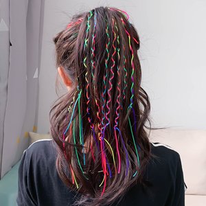 Woman's dark hair styled with colorful rainbow elastic beading cords woven in