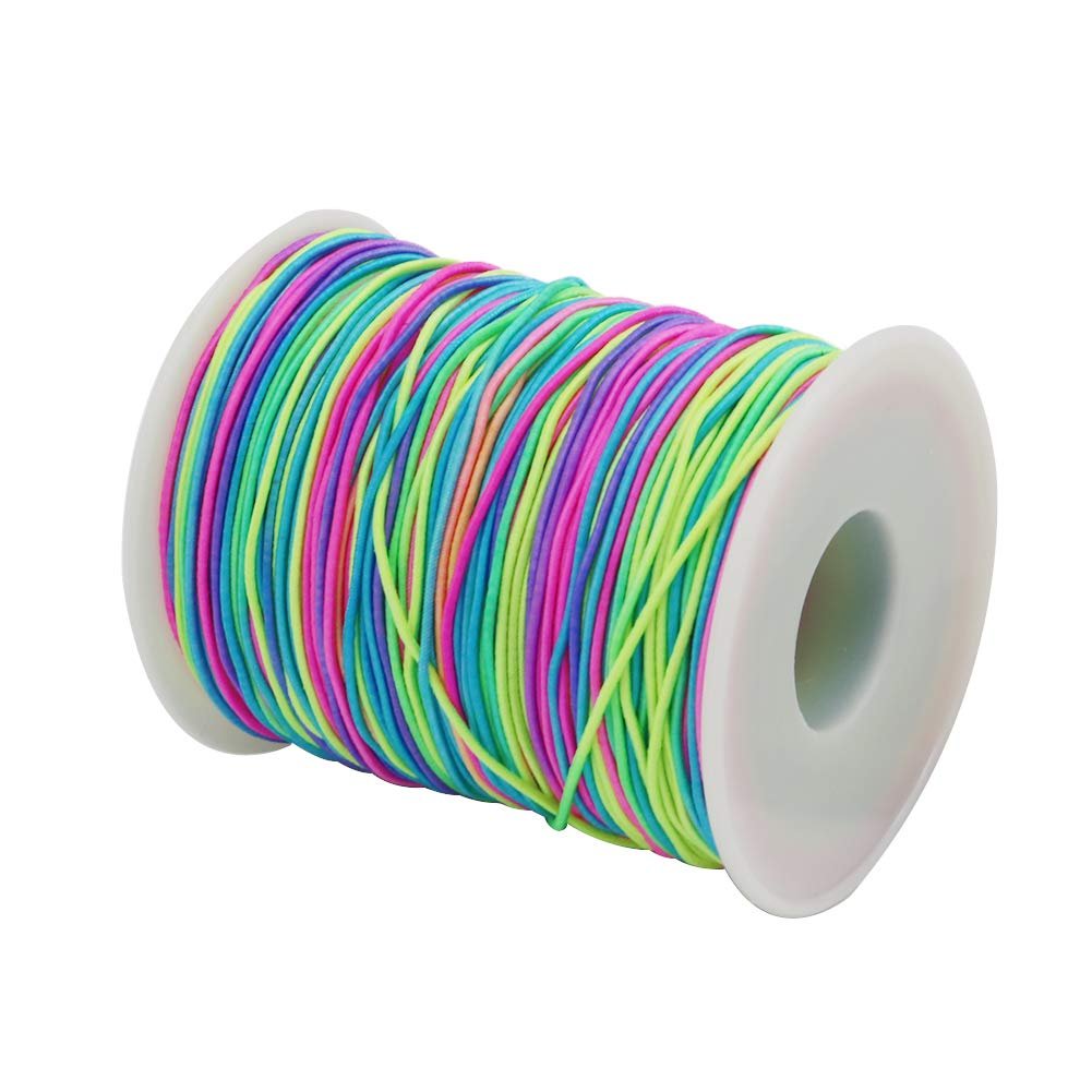 Spool of rainbow elastic beading cord with pink, blue, green, and purple strands on a white background.