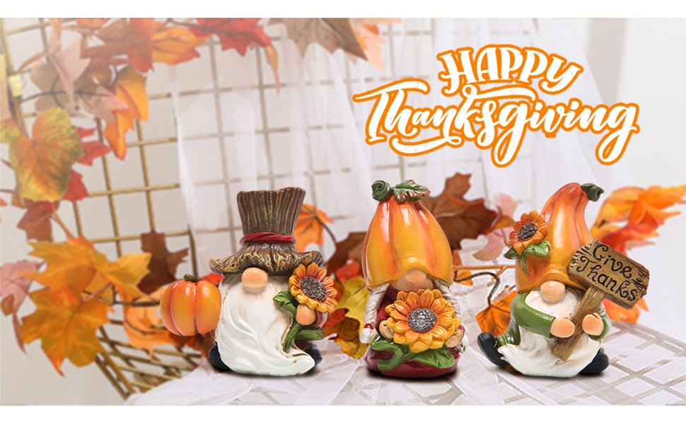 Three fall-themed gnome statues with sunflowers and pumpkins, one holding a 'Give Thanks' sign.