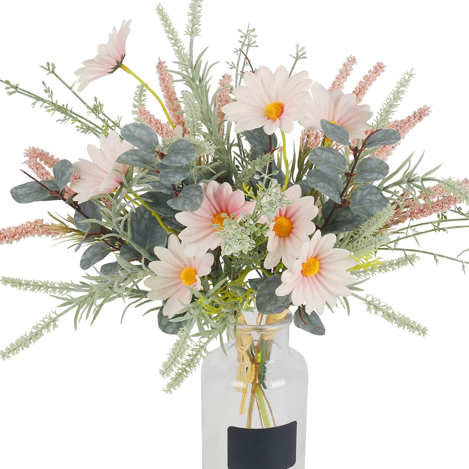 Artificial pink daisy and eucalyptus bouquet in a clear glass vase with a black label