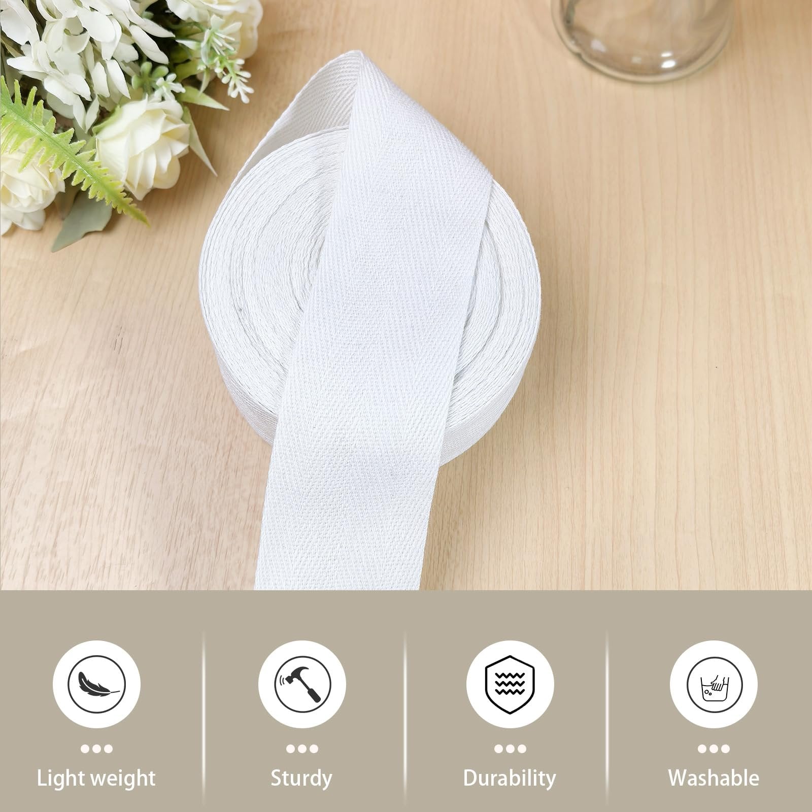 Roll of white cotton herringbone twill tape on a wooden surface with floral accents and feature icons below.